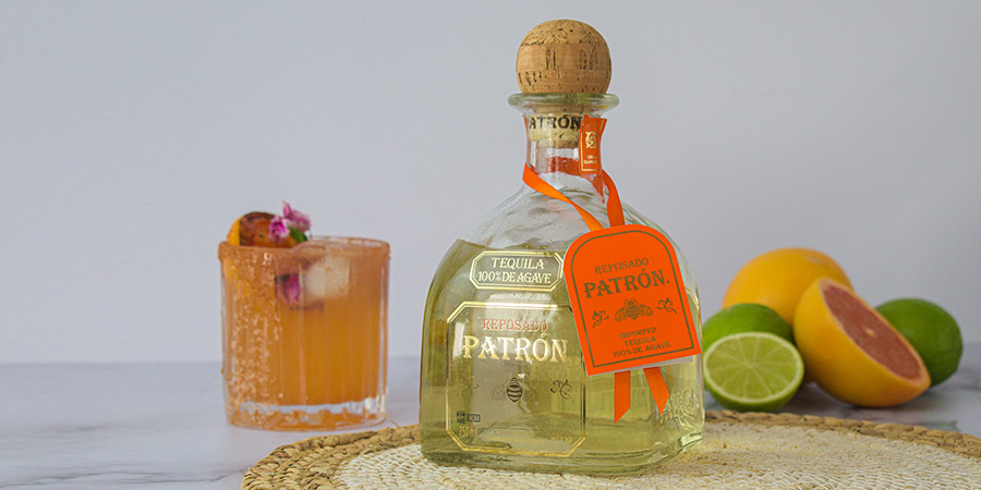 a bottle and a glass of Patron Tequila Reposado Paloma cocktail